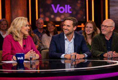 Talkshow setting met Volt logo op mok en achtergrond