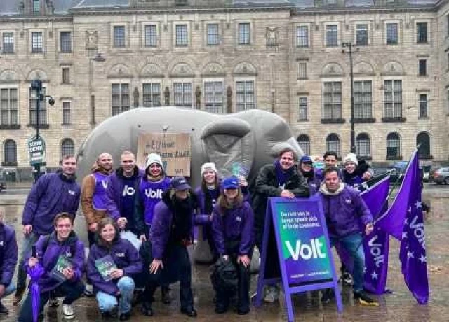 Groeps foto van Volter die flyeren op straat voor de tweede kamer verkiezingen. Ze staan voor een opblaas olifant