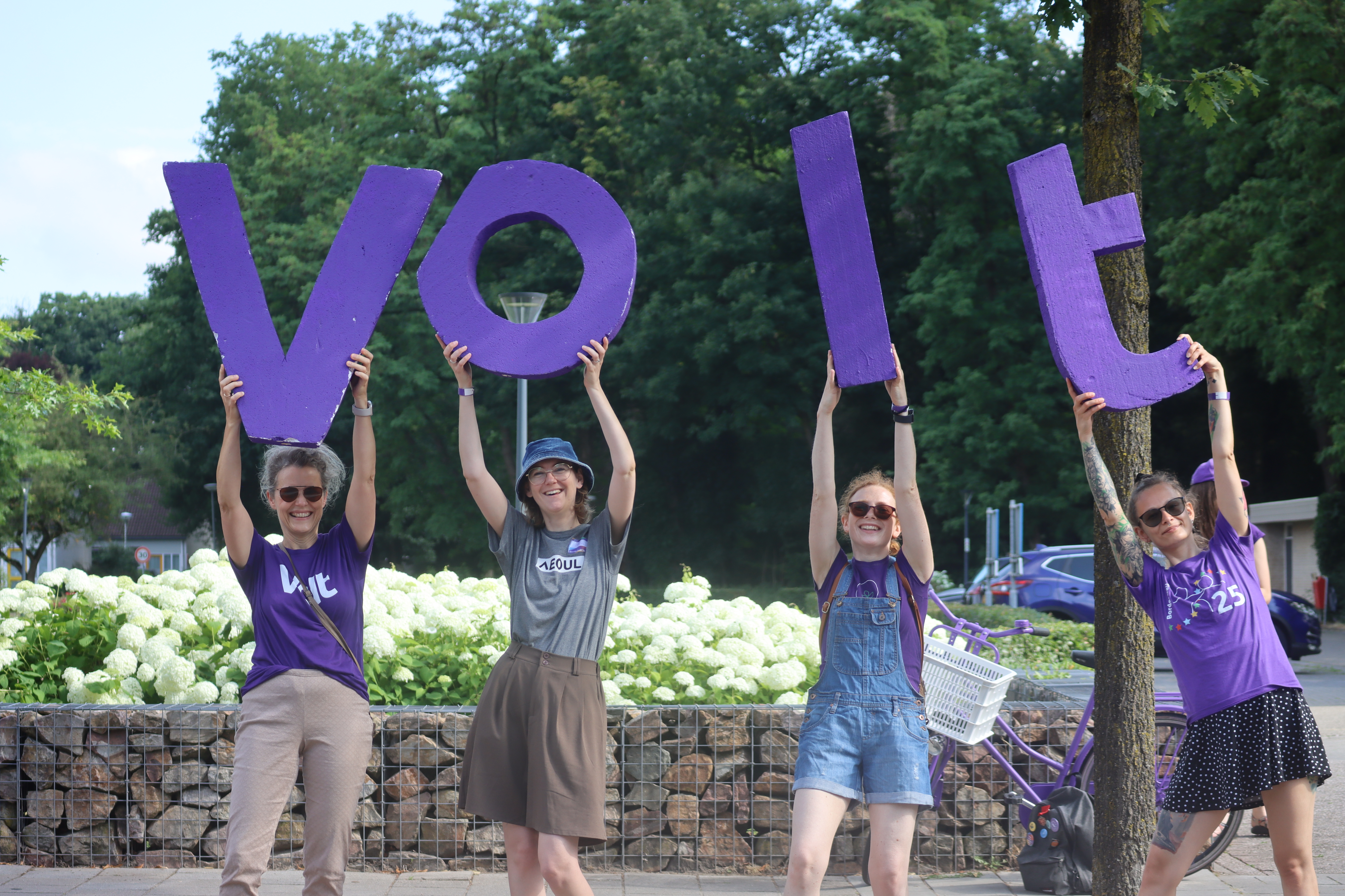 4 people with the letters VOLT
